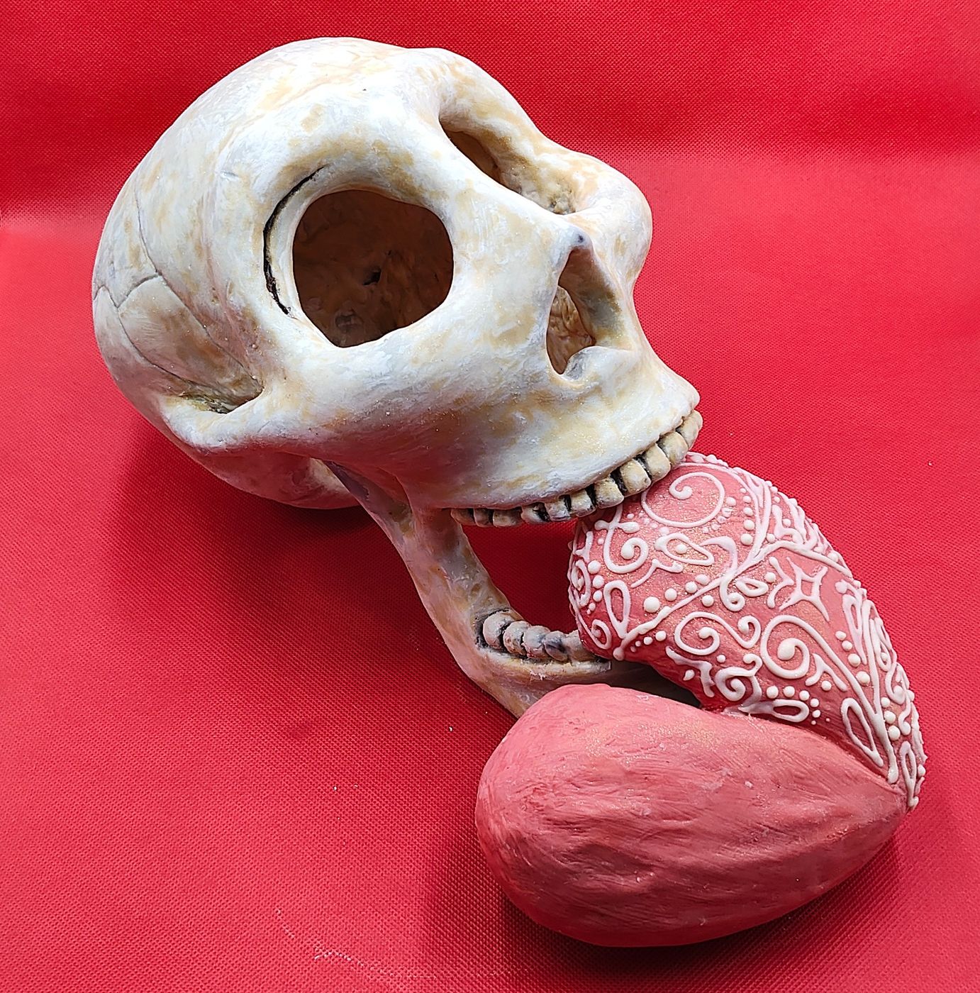 Sculpted Skull Holding Piped Heart